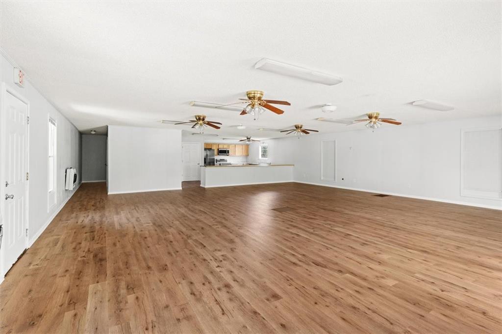 210 Hood Street Calhoun, GA 30701 - Photo 25 of 59 an empty room with wooden floor and white walls