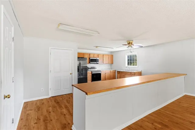 a kitchen with stainless steel appliances granite countertop a sink and a stove
