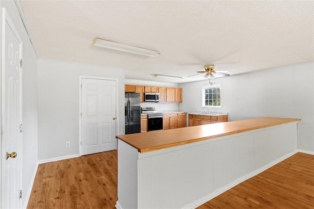 210 Hood Street Calhoun, GA 30701 - Photo 27 of 59 a kitchen with stainless steel appliances a refrigerator and a stove