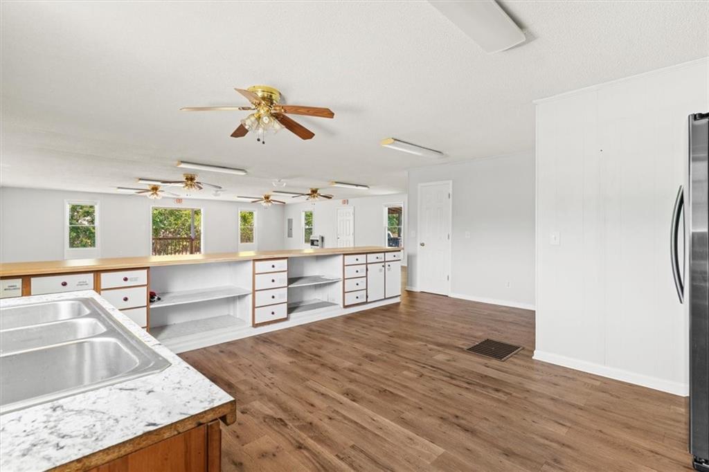 210 Hood Street Calhoun, GA 30701 - Photo 32 of 59 a kitchen with stainless steel appliances granite countertop a sink and a stove