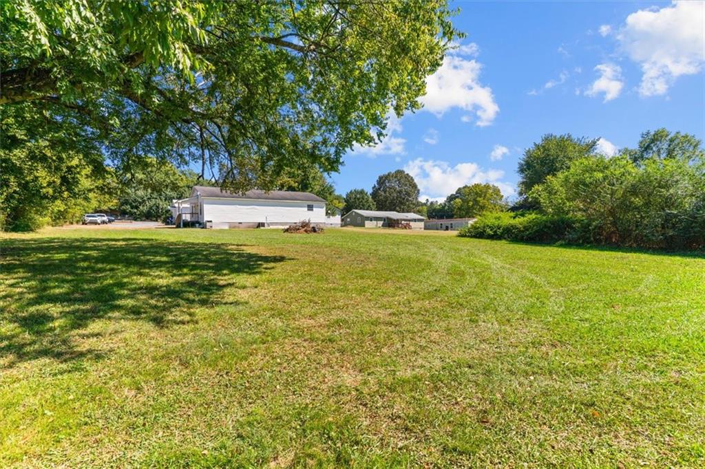 210 Hood Street Calhoun, GA 30701 - Photo 36 of 59 a view of yard with swimming pool and green space