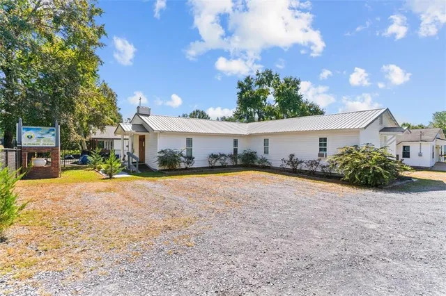 a view of a house with swimming pool and a yard