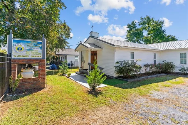 a front view of a house with garden