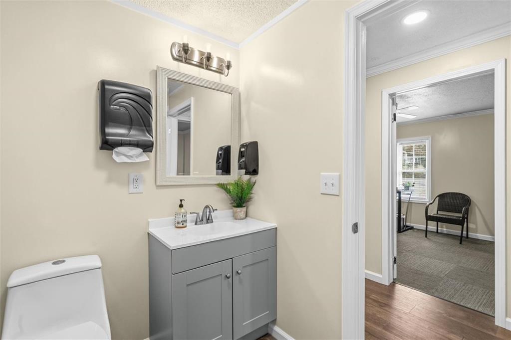 210 Hood Street Calhoun, GA 30701 - Photo 51 of 59 a en suite bathroom with a toilet a sink and a mirror