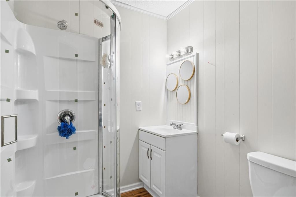 210 Hood Street Calhoun, GA 30701 - Photo 55 of 59 a bathroom with a bathtub sink vanity and mirror