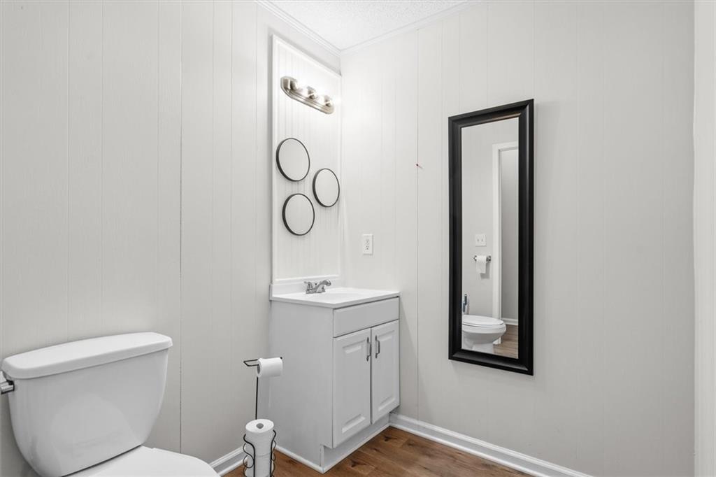 210 Hood Street Calhoun, GA 30701 - Photo 57 of 59 a bathroom with a toilet a sink and mirror
