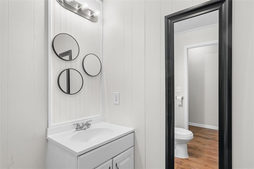 210 Hood Street Calhoun, GA 30701 - Photo 58 of 59 a bathroom with a toilet sink and mirror