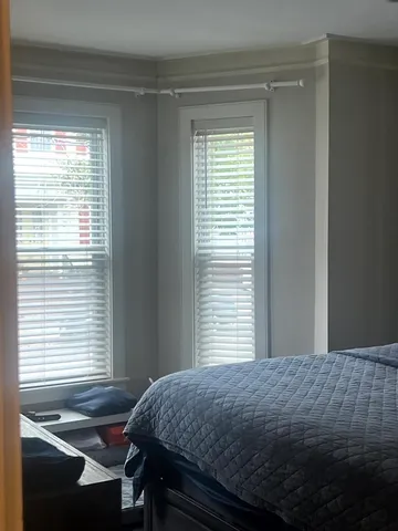 a bedroom that has a bed and a window