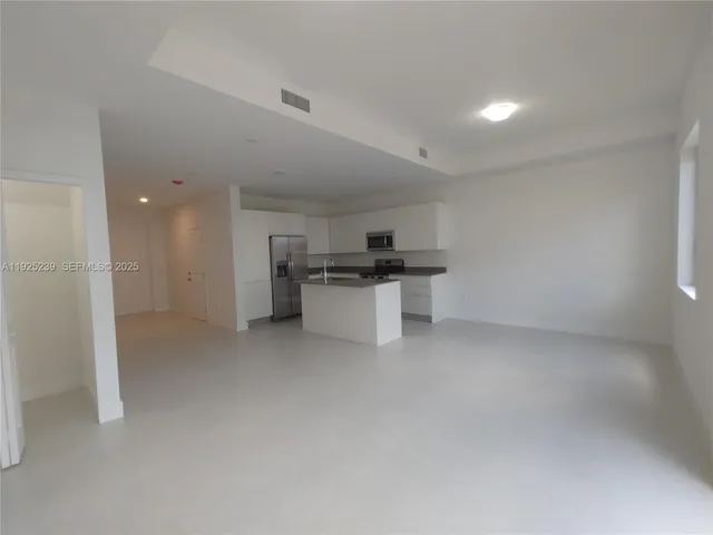 a kitchen with stainless steel appliances a refrigerator and a sink