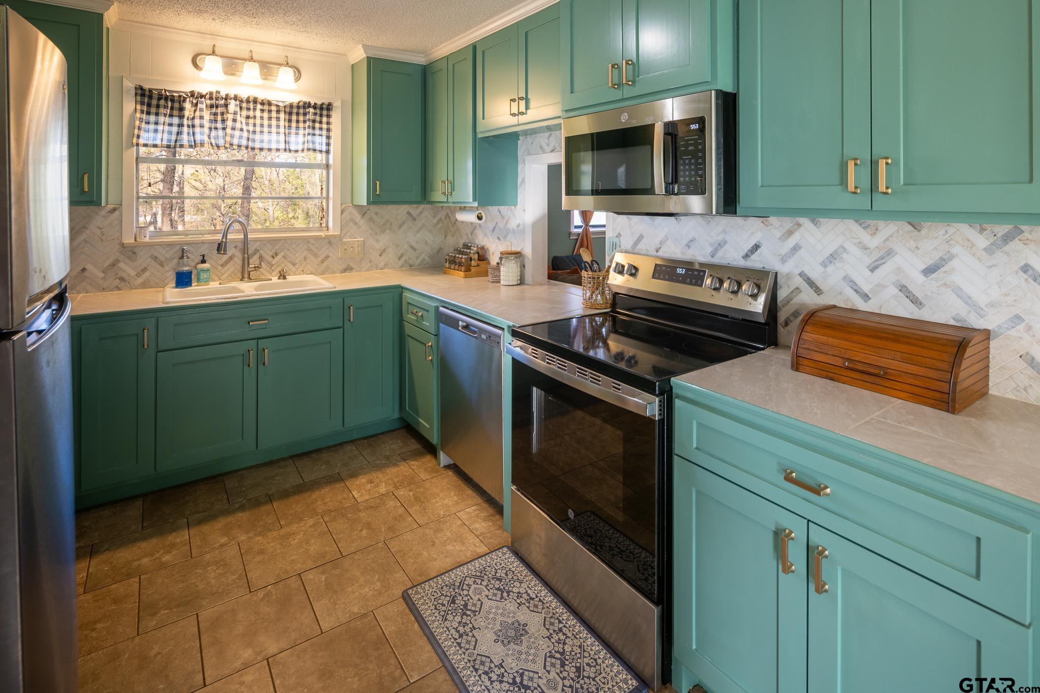 10733 County Road 4150 Tyler, TX 75704 - Photo 11 of 48 a kitchen with a sink and a stove top oven