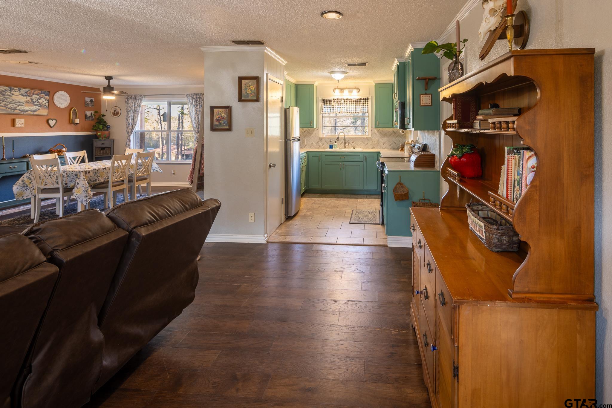 10733 County Road 4150 Tyler, TX 75704 - Photo 13 of 48 a living room with furniture a flat screen tv and a book shelf