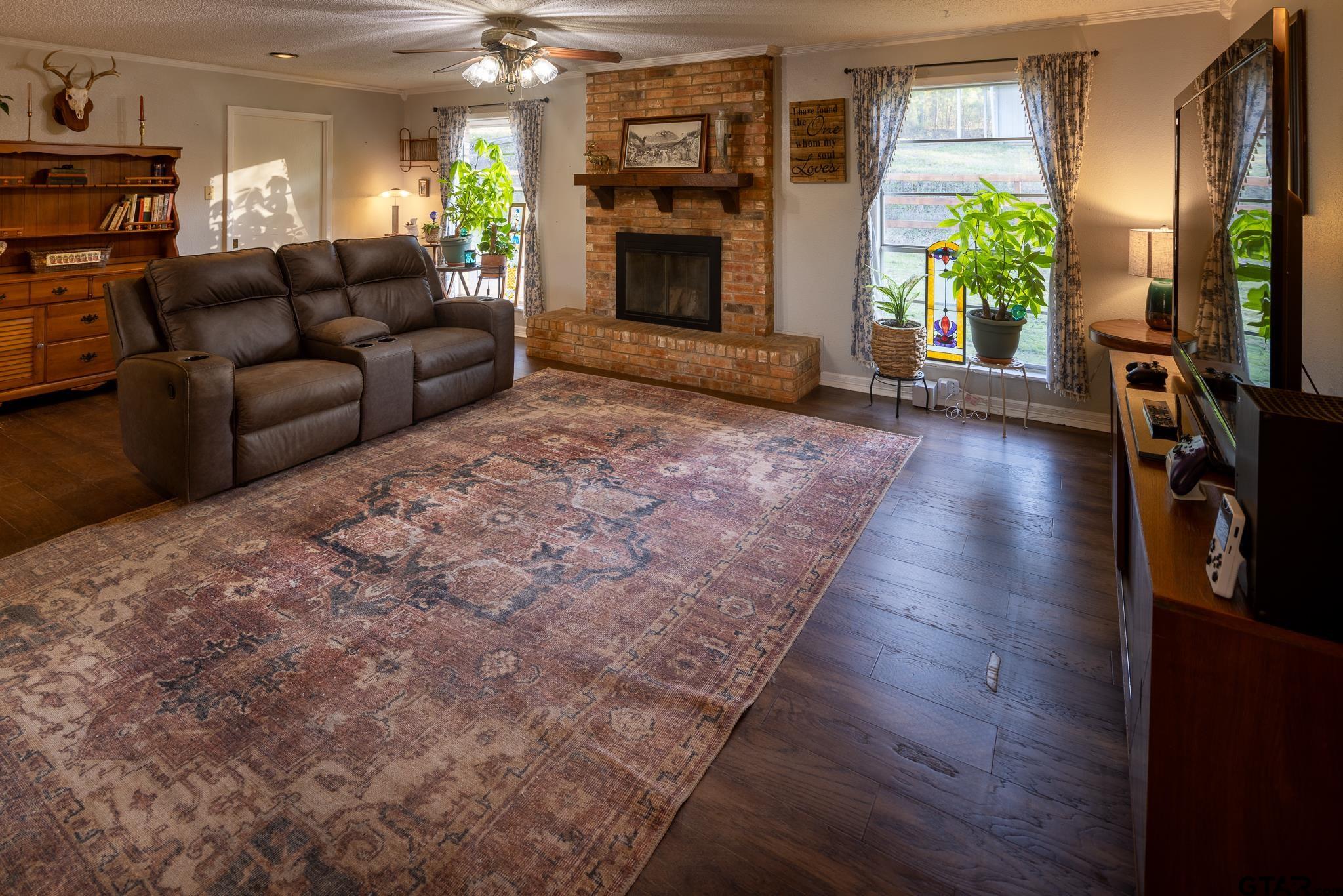 10733 County Road 4150 Tyler, TX 75704 - Photo 15 of 48 a living room with furniture and a fireplace