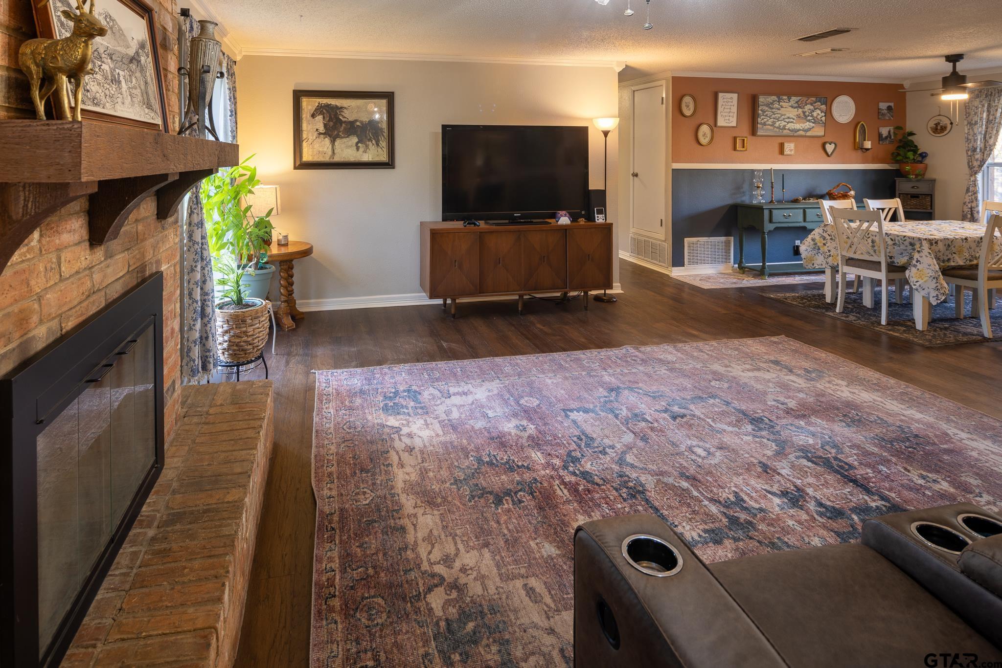 10733 County Road 4150 Tyler, TX 75704 - Photo 16 of 48 a living room with furniture and a flat screen tv