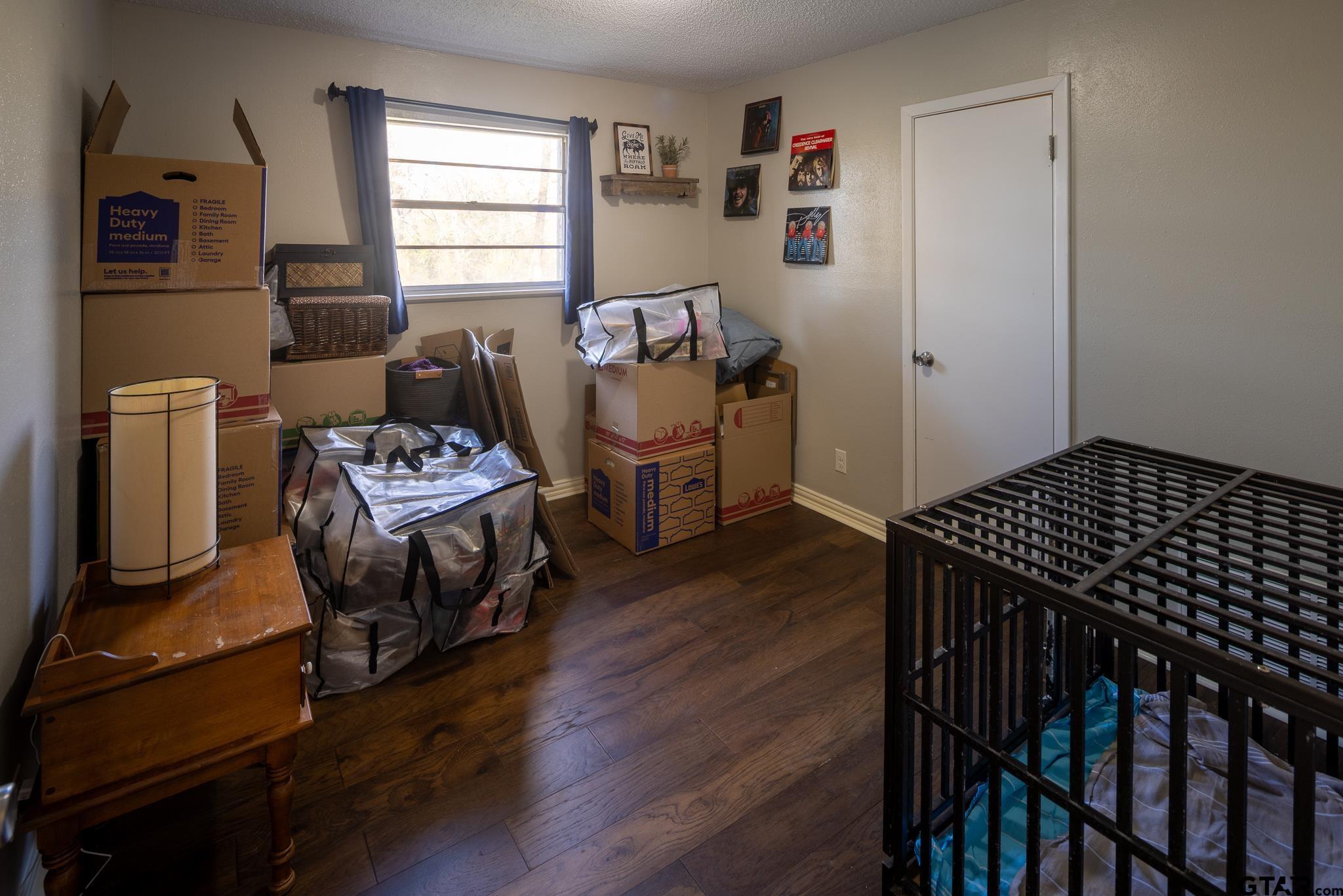 10733 County Road 4150 Tyler, TX 75704 - Photo 27 of 48 a bedroom with a bed and wooden floor