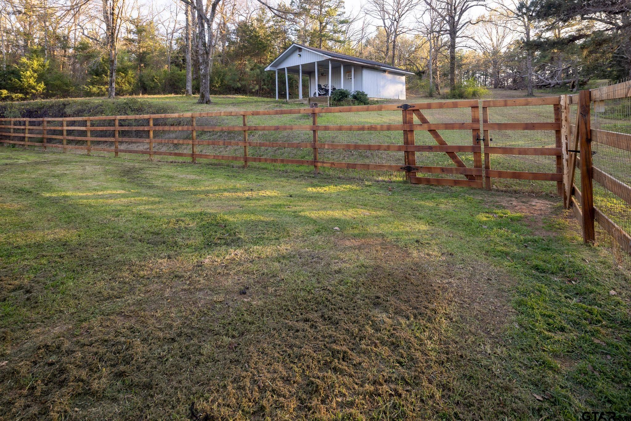 10733 County Road 4150 Tyler, TX 75704 - Photo 3 of 48 a view of a yard with wooden fence