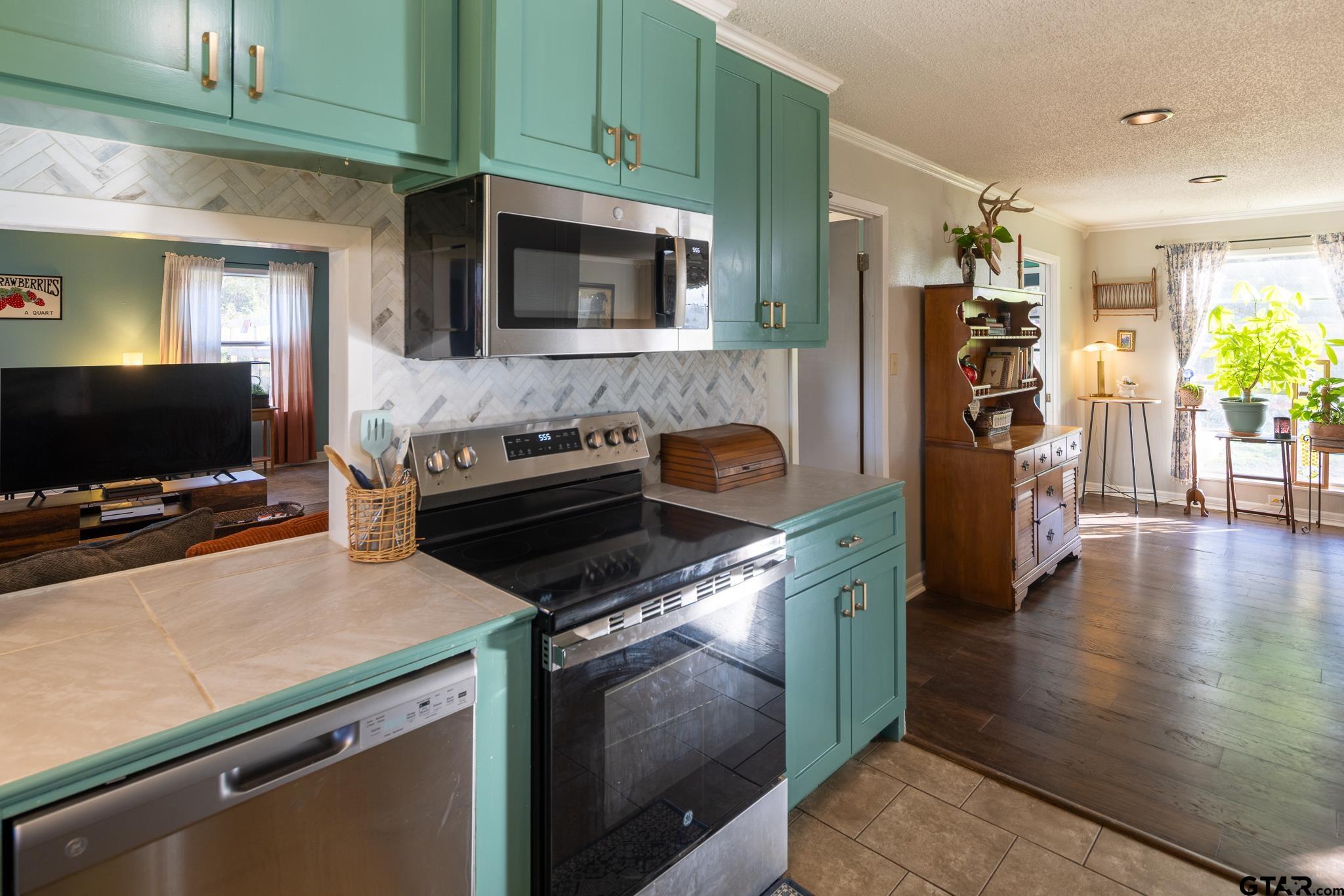 10733 County Road 4150 Tyler, TX 75704 - Photo 10 of 48 a kitchen with a stove and a microwave