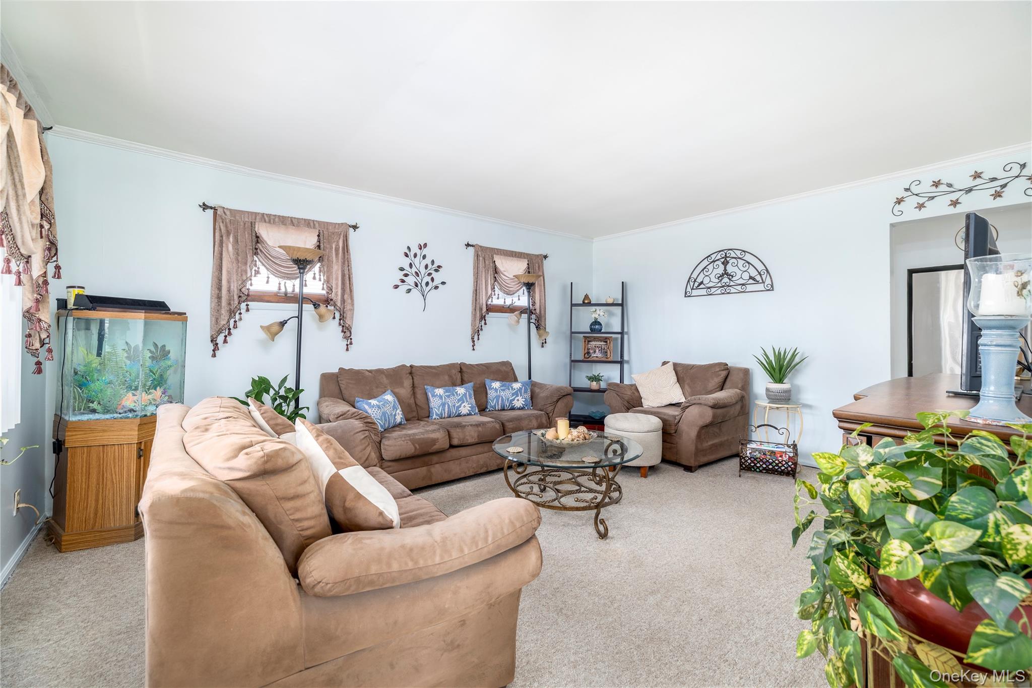 712 Nightingale Road West Hempstead, NY 11552 - Photo 2 of 23 Carpeted living area with ornamental molding