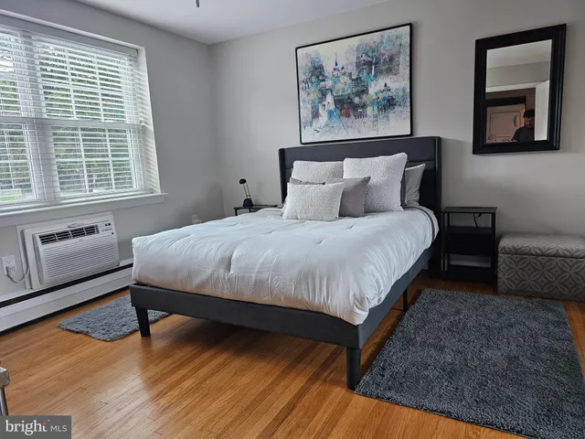 a bedroom with a bed and a couch