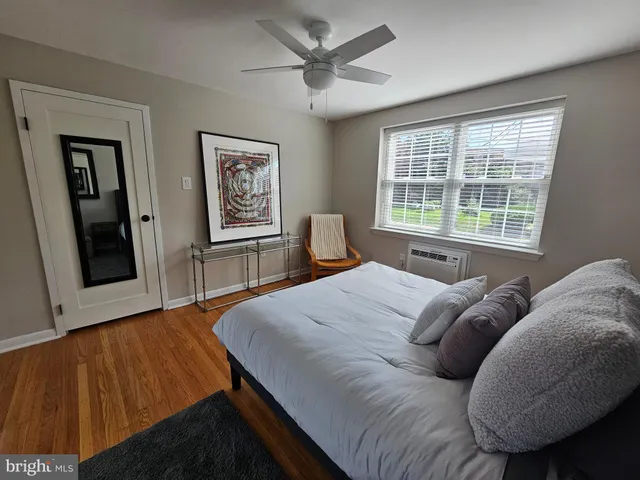 a bed sitting in a bedroom next to a window
