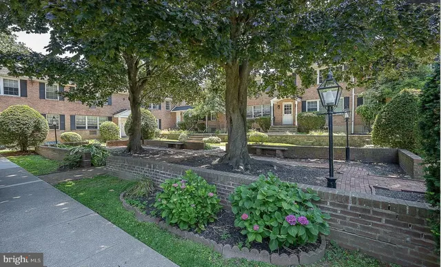 a view of a house with a yard and tree s