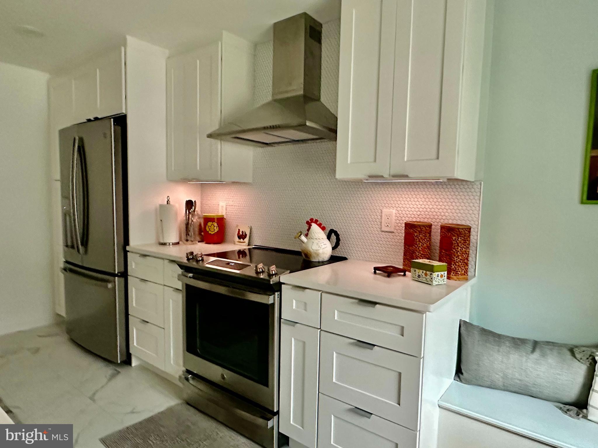 1334 Montgomery Avenue, Unit B1 Narberth, PA 19072 - Photo 6 of 17 a kitchen with stainless steel appliances granite countertop a stove a refrigerator and a white cabinets