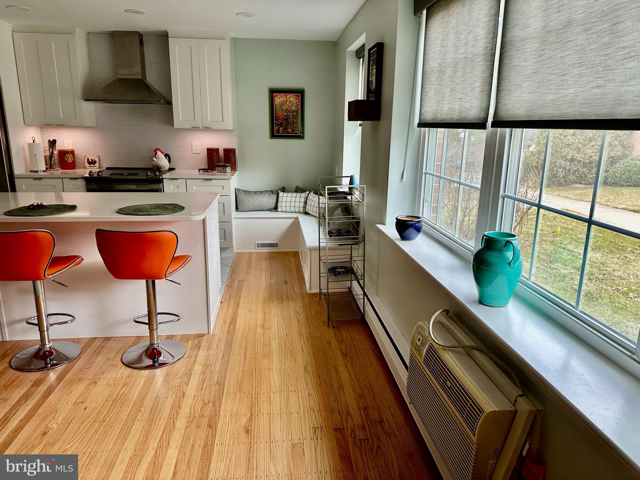 1334 Montgomery Avenue, Unit B1 Narberth, PA 19072 - Photo 7 of 17 a kitchen with stainless steel appliances kitchen island granite countertop wooden floors and large window