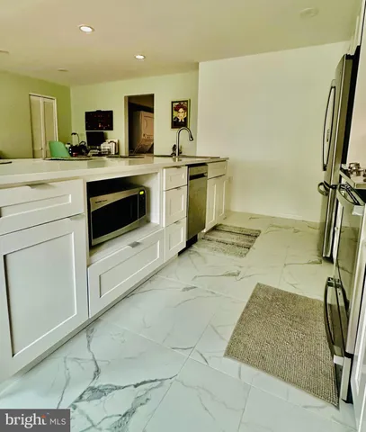 a kitchen with stainless steel appliances granite countertop a sink and a stove