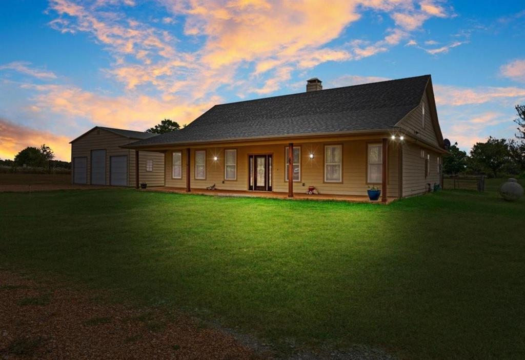 a view of a house with a big yard with wooden fence