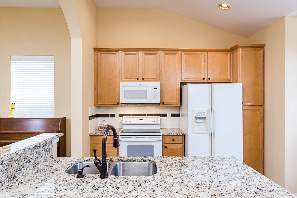 8308 Chimneycap Drive Raleigh, NC 27613 - Photo 13 of 23 Luxury counters and tile backsplash compliment 42 inch maple cabinets and pantry! Kitchen