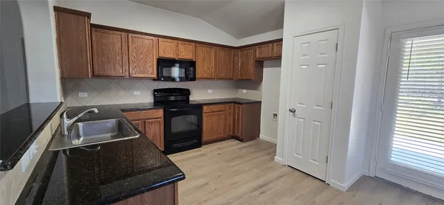 a kitchen with a sink stove and microwave