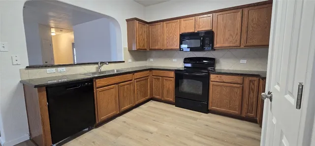 a kitchen with a sink stove and microwave