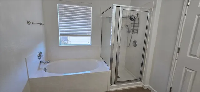a bathroom with a tub and shower