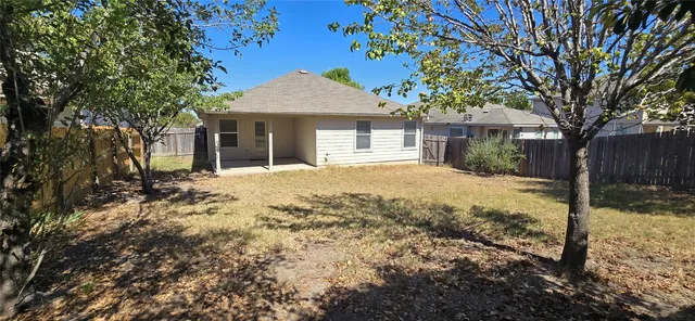 a front view of a house with a yard covered in snow