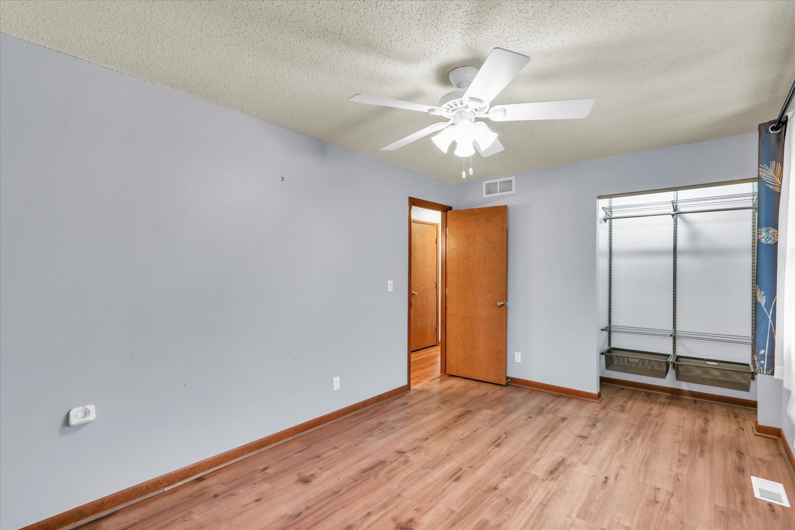 1908 Barberry Circle Champaign, IL 61821 - Photo 18 of 33 an empty room with wooden floor closet and fan