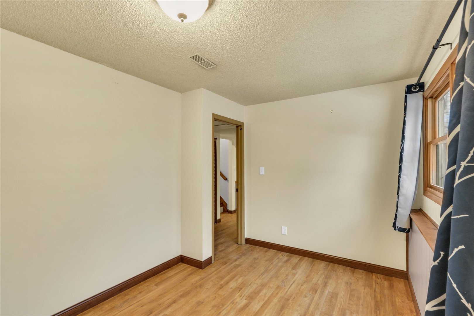 1908 Barberry Circle Champaign, IL 61821 - Photo 22 of 30 a view of an empty room with wooden floor and a window