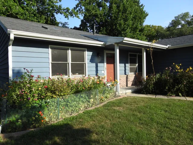 a front view of house with yard and green space