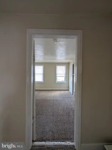 a view of empty room with a fireplace