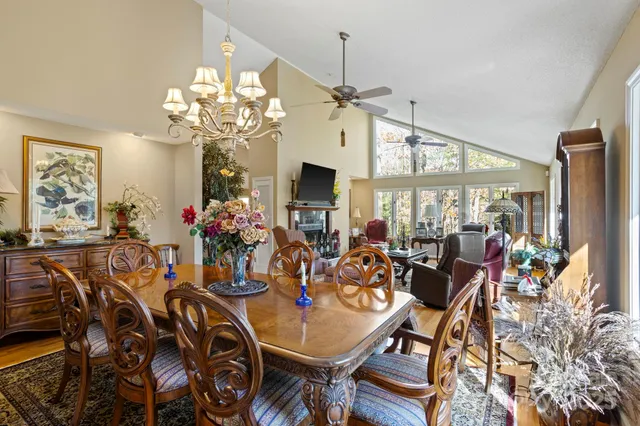 a view of a dining room with furniture a chandelier and wooden floor