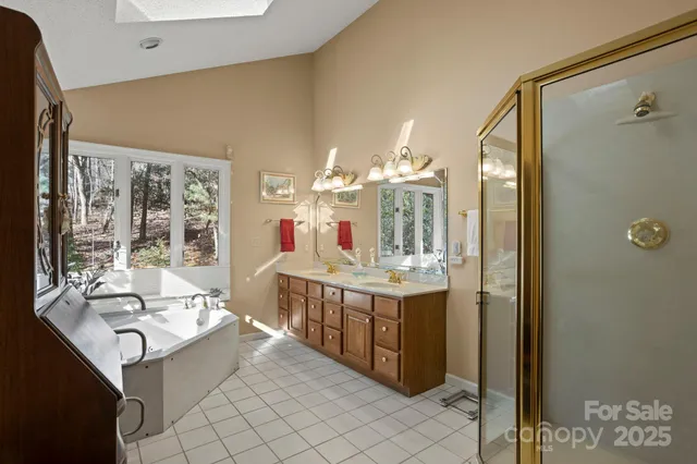 a bathroom with a tub sink and large mirror