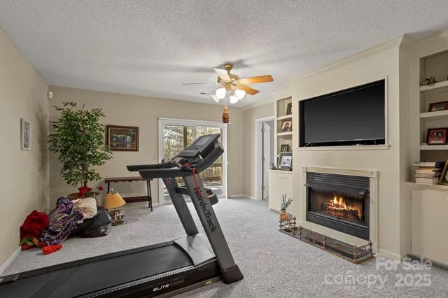 a room with gym equipment and a flat screen tv