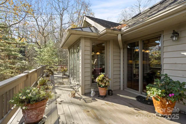 a balcony with wooden floor and fence