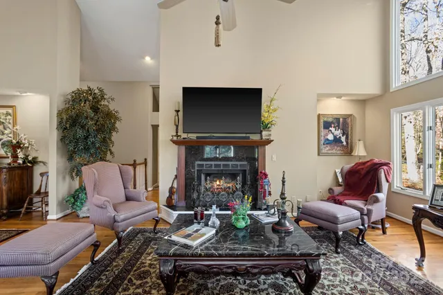 a living room with furniture a fireplace and a flat screen tv