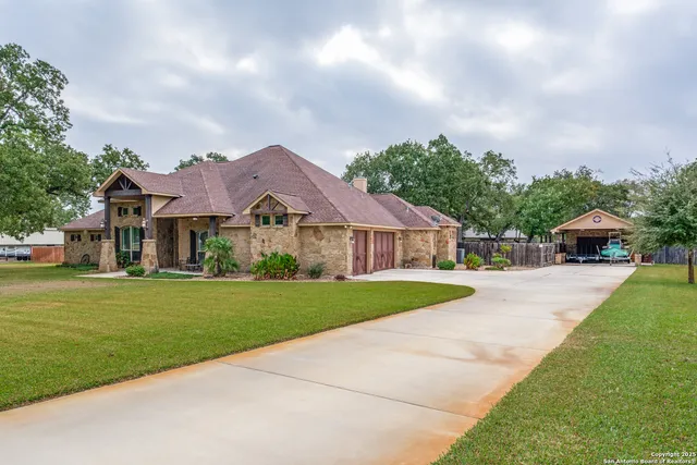 a front view of a house with a garden and yard