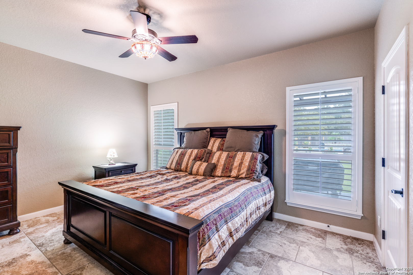 109 Bobcat Bend La Vernia, TX 78121 - Photo 16 of 36 a bedroom with a bed and a chandelier