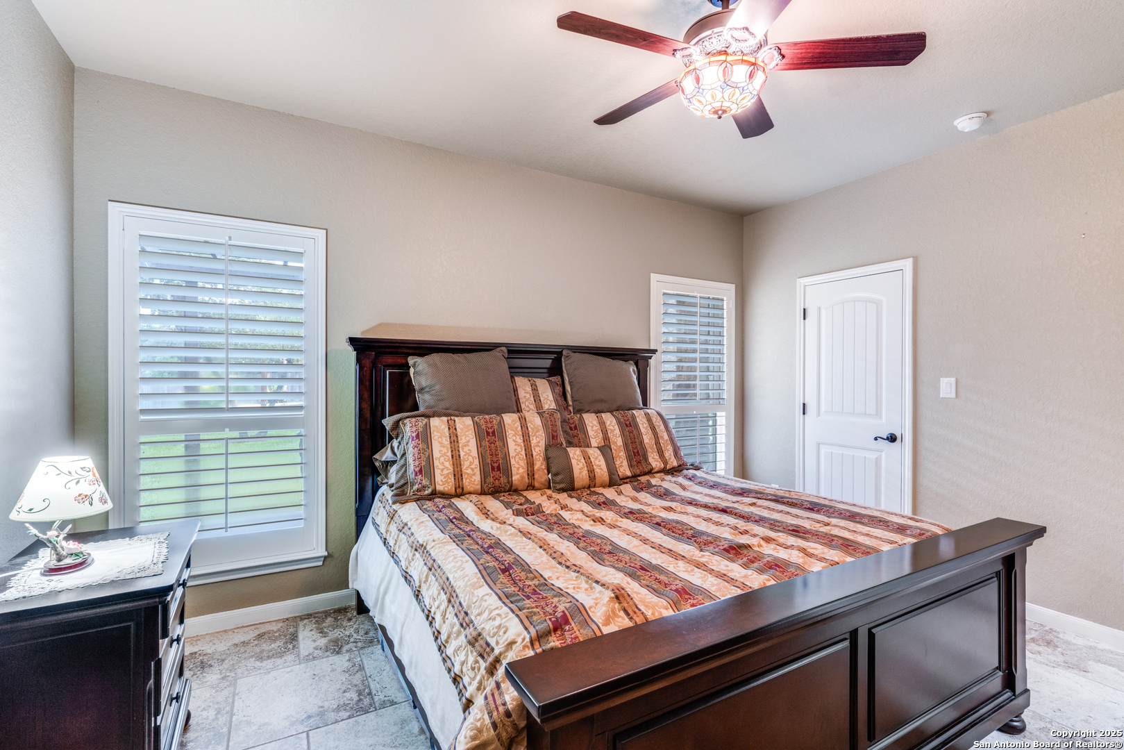 109 Bobcat Bend La Vernia, TX 78121 - Photo 17 of 36 a bedroom with a bed and a chandelier