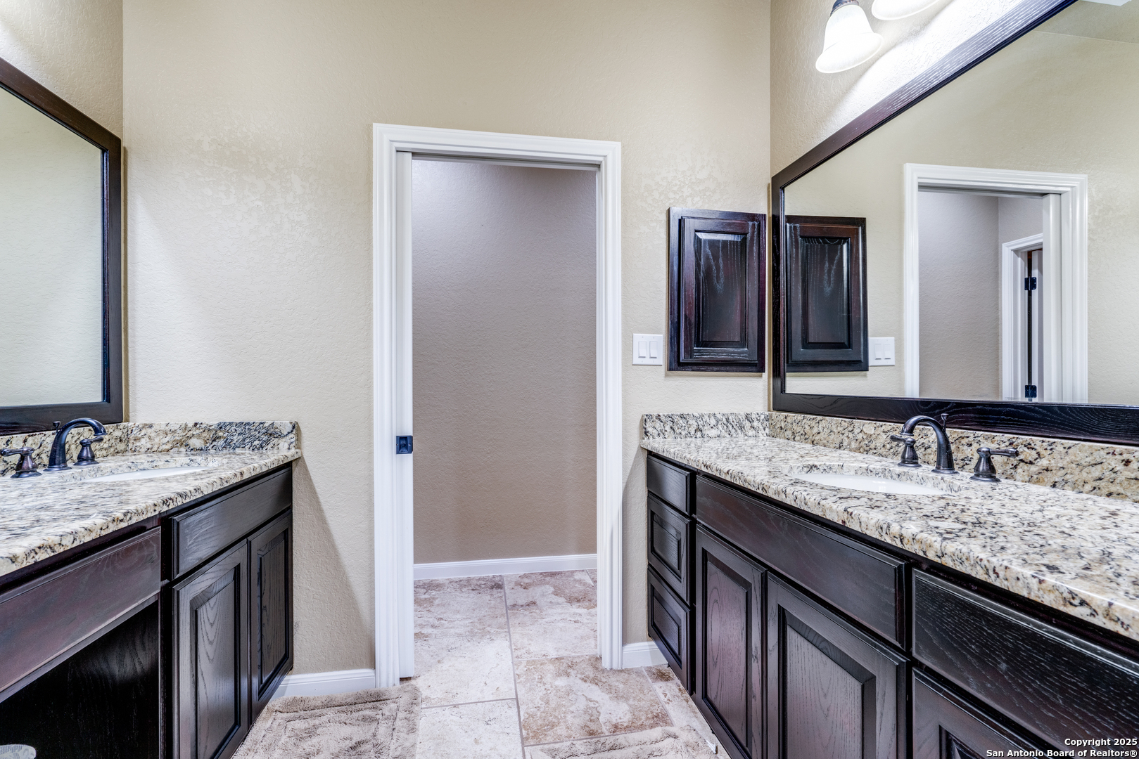 109 Bobcat Bend La Vernia, TX 78121 - Photo 19 of 36 a bathroom with a granite countertop sink and a mirror
