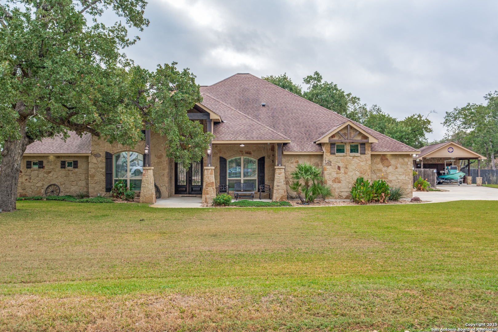 109 Bobcat Bend La Vernia, TX 78121 - Photo 2 of 36 a front view of a house with a garden and deck