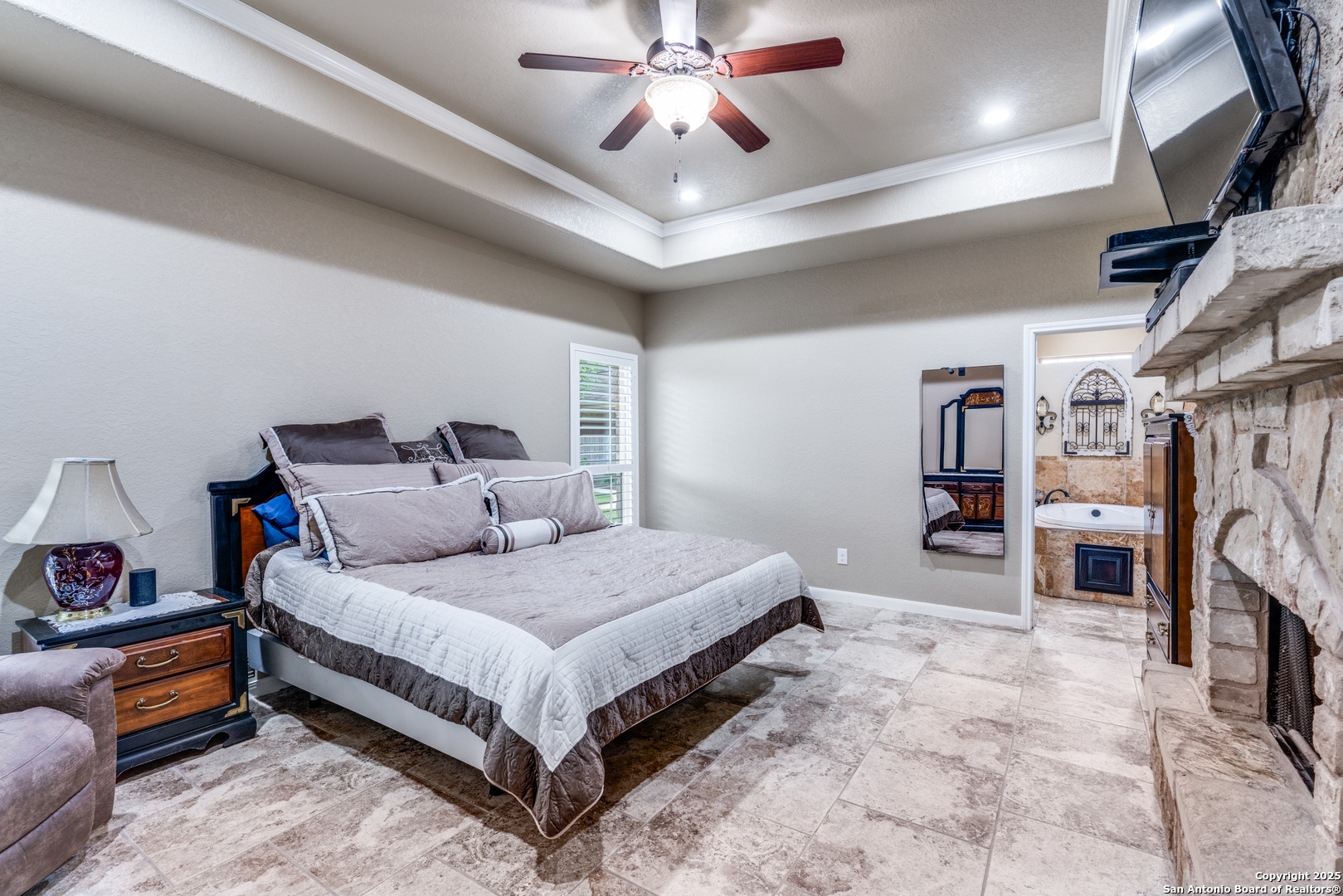 109 Bobcat Bend La Vernia, TX 78121 - Photo 22 of 36 a bedroom with a bed and a chandelier