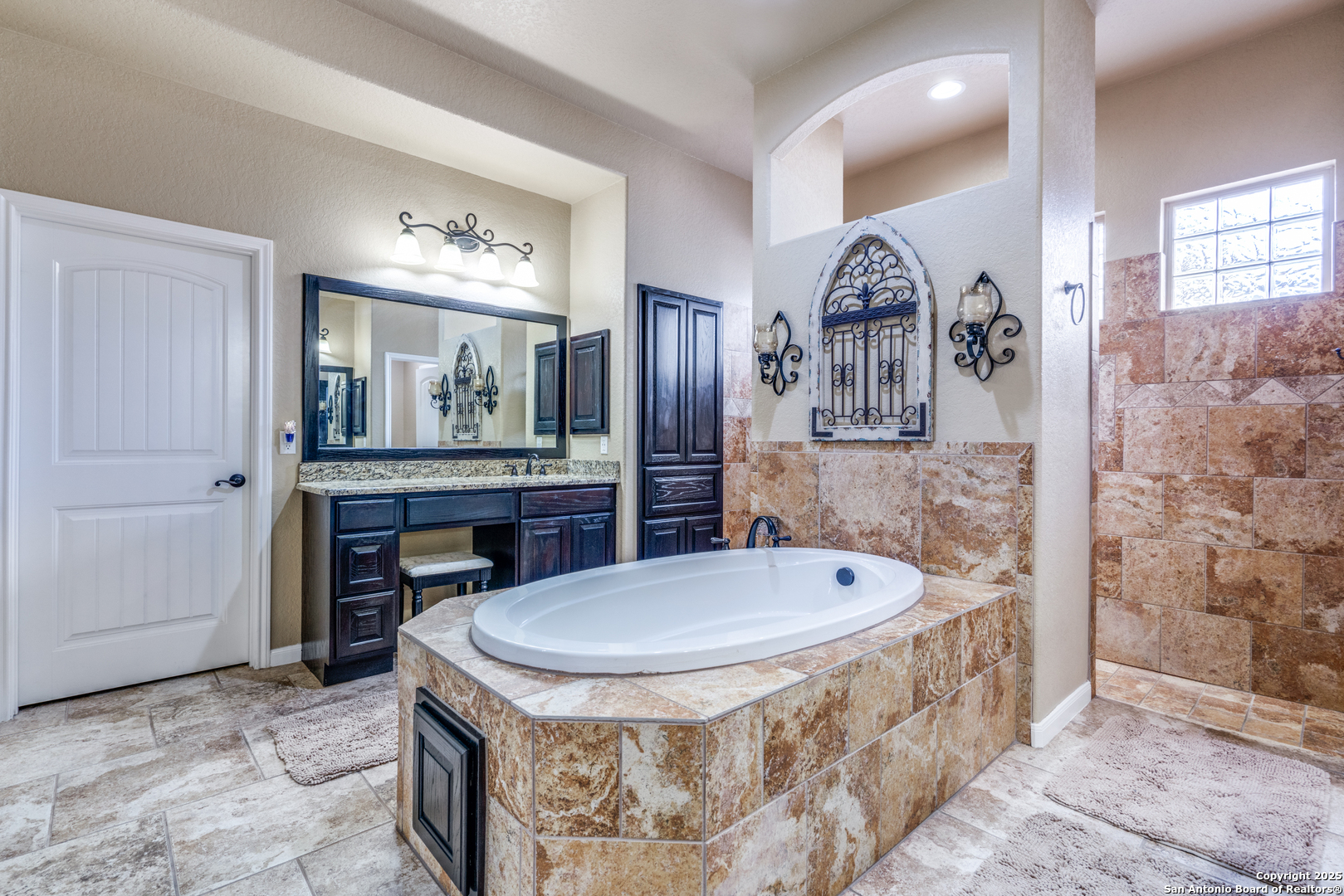 109 Bobcat Bend La Vernia, TX 78121 - Photo 27 of 36 a bathroom with a tub sink and mirror