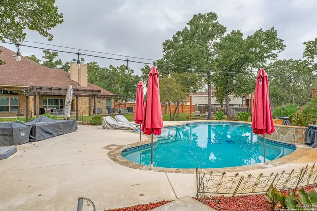 a view of a house with a backyard and a small yard